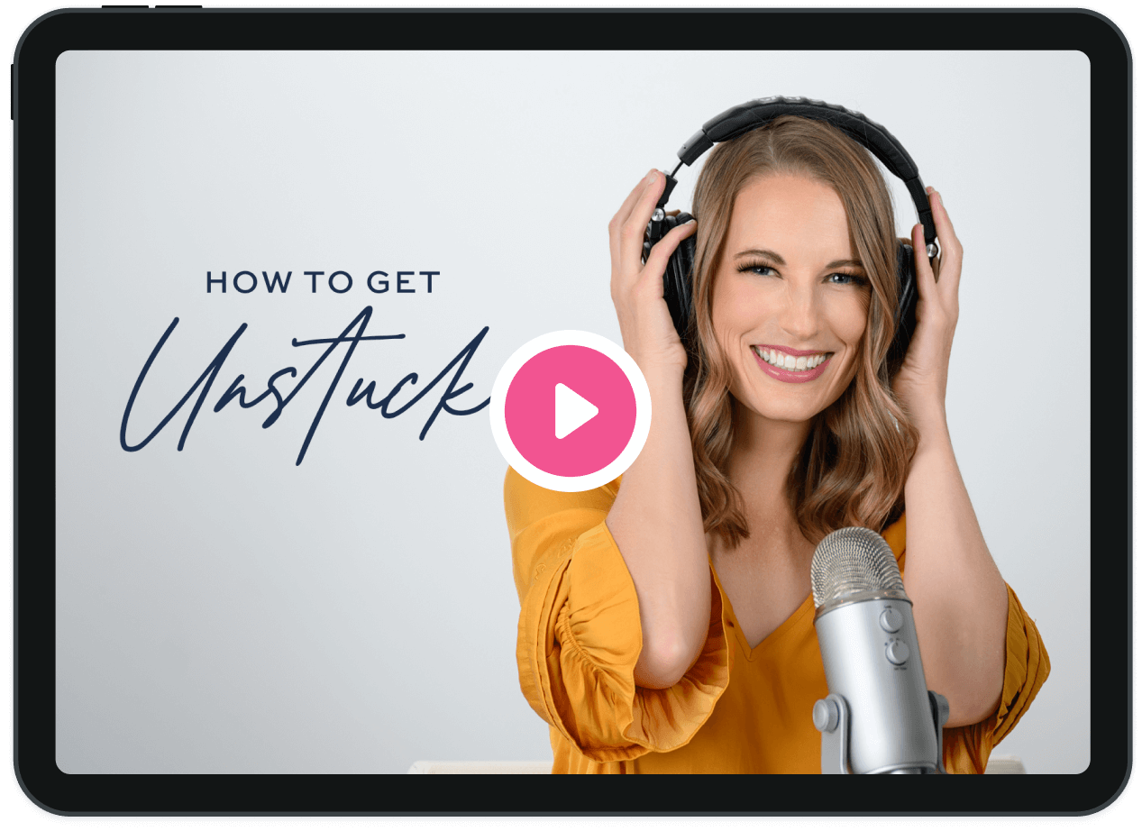A woman in a yellow top smiles while wearing headphones and speaking into a microphone. The text reads "How to Get Unstuck" with a play button icon in the middle.